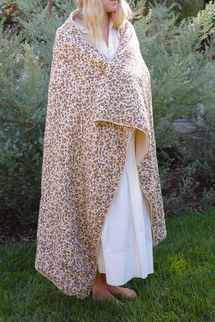 Model wrapped in coconut floral Sherpa Cottage blanket — cozy holiday comfort by House No 23”
