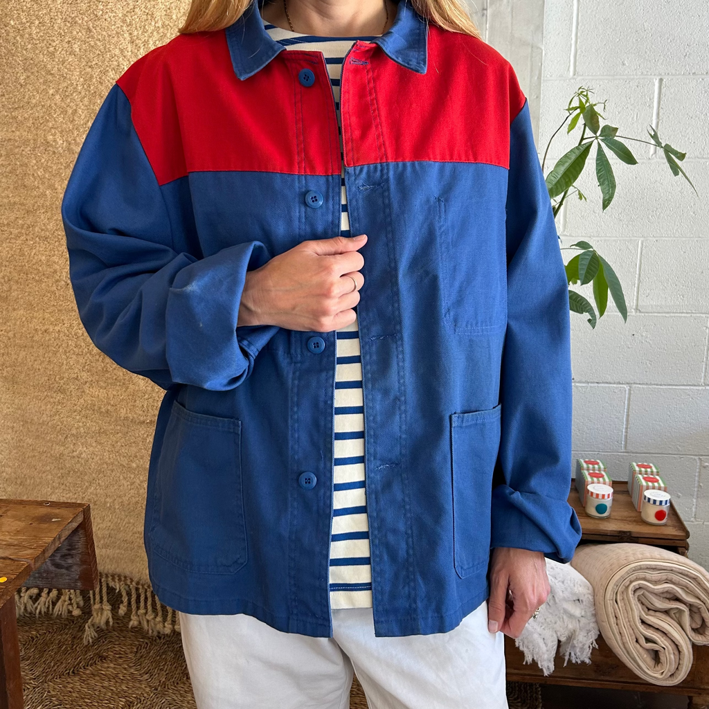 Person wearing a blue and red jacket in a casual indoor setting