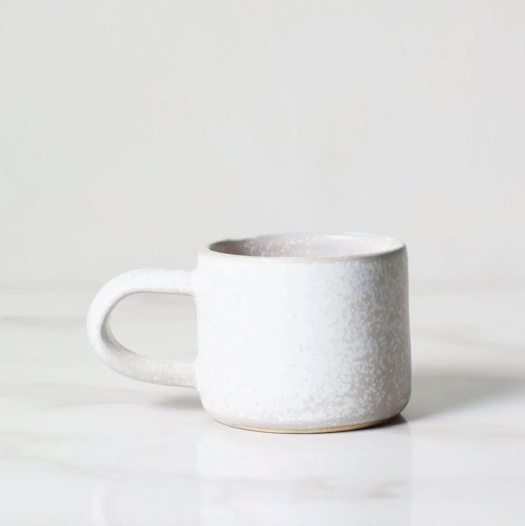 White ceramic mug on a light gray background
