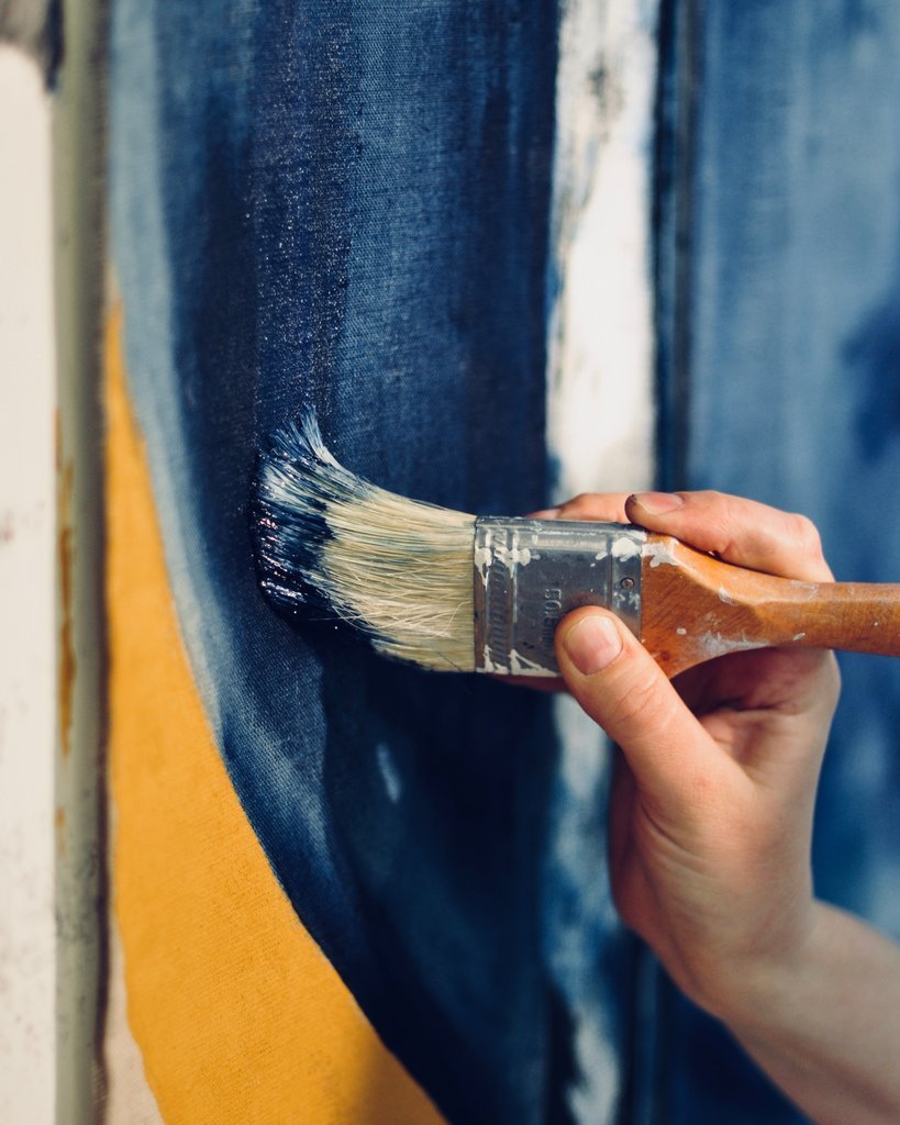 paintbrush stroking against an art canvas