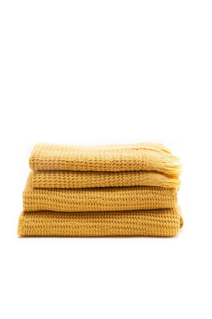 honey comb weaved bath towel in the color mustard